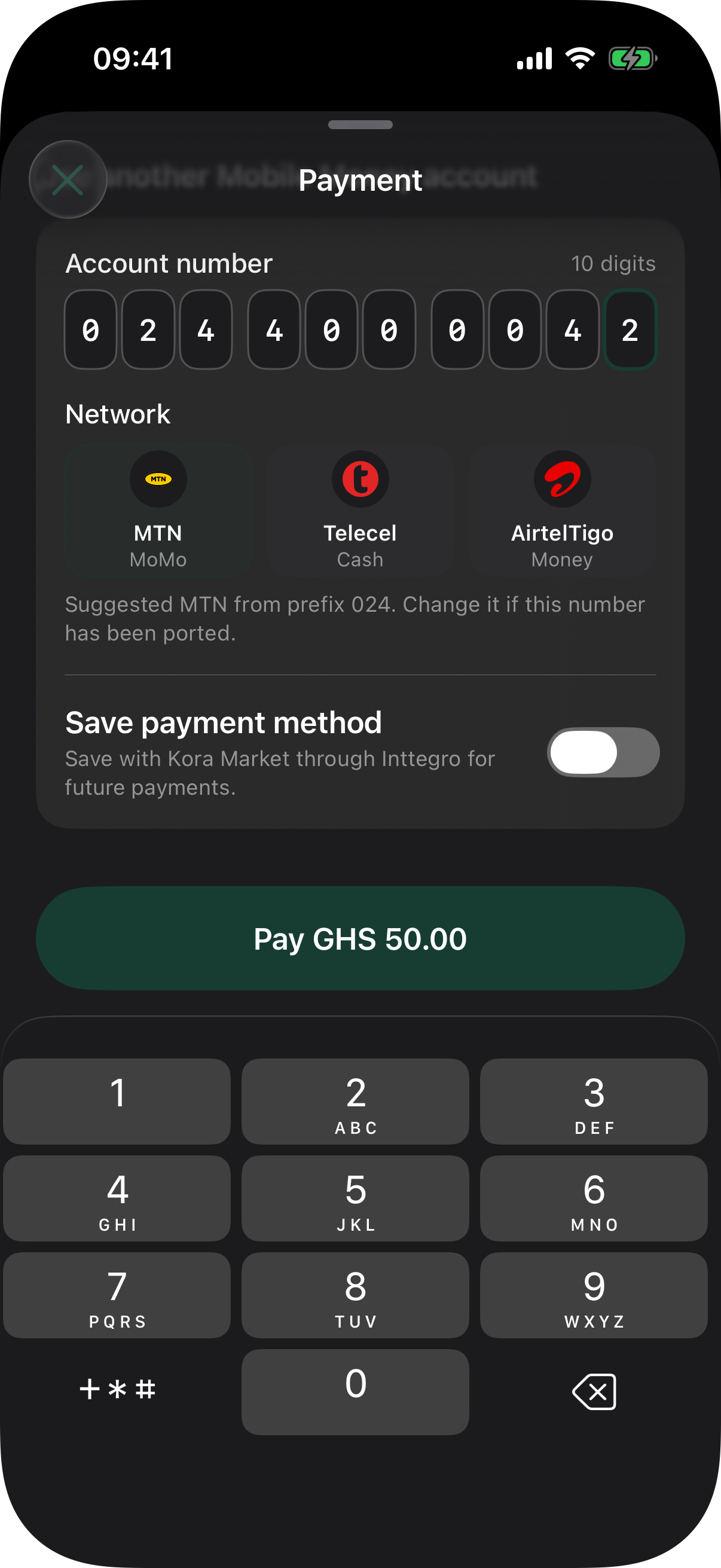 Native Inttegro payment sheet in dark appearance with an active segmented Mobile Money number field, the iOS phone keypad, and logo-backed MTN MoMo, Telecel Cash, and AirtelTigo Money network choices.